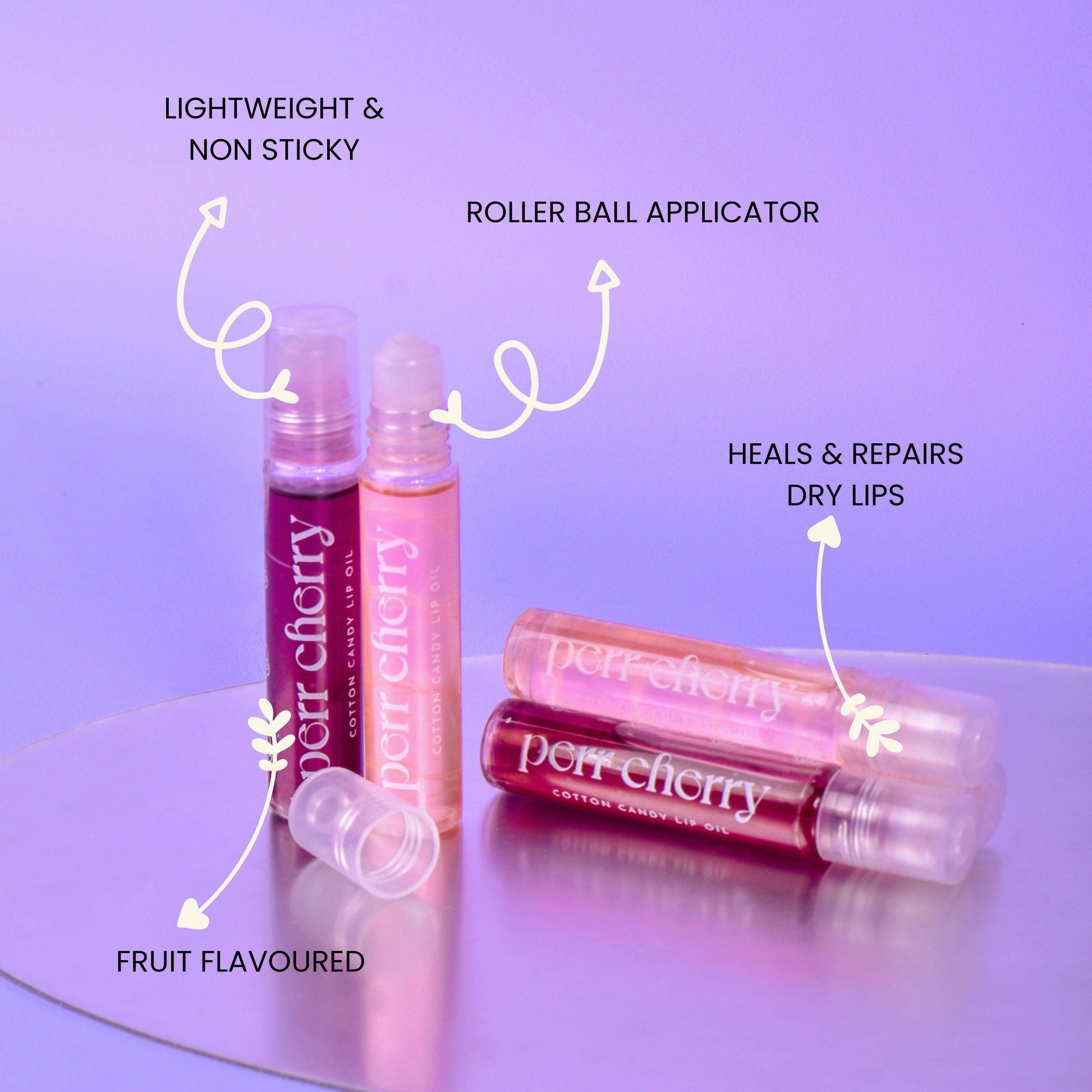Roller ball lip oil with cherry flavor on a purple background